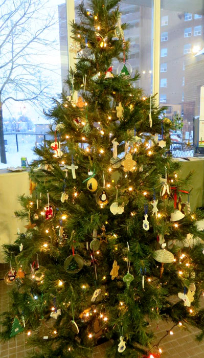 Guild holiday tree with pottery, gourd and wooden ornaments
