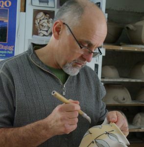 Dan Hill painting a teapot