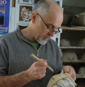 Dan Hill painting a teapot