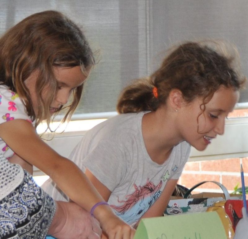 Campers displaying finished projects for parents