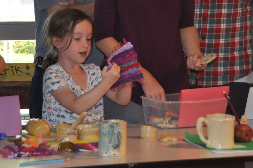 Campers displaying finished projects for parents