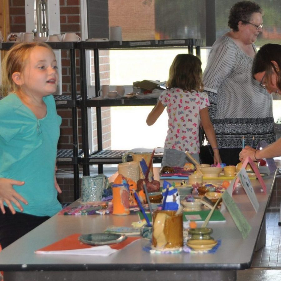Campers showing parents work they made