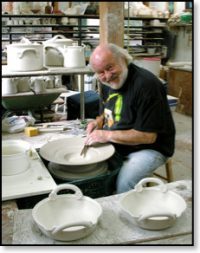 A photo of Robin Hopper working at his wheel in his studio