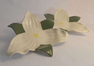 two hand built plates in the shape of white trilliums with green leaves