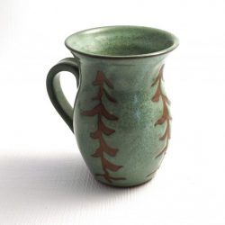 green mug with wax resist white pine trees showing red clay - Liz Sine