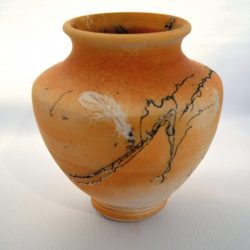 Horse hair and feather naked raku vase with an orange hue - Anne Young