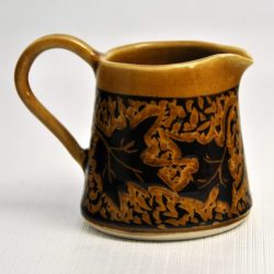 maple syrup pitcher in amber glaze with maple leaves carved in relief - Karina Bates