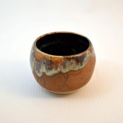 goblet with exterior carving and runny glaze over rust matt glaze - Paul Keelan