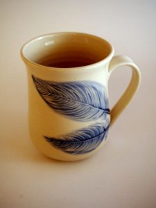 porcelain mug painted and carved with blue feathers - Priya Harding