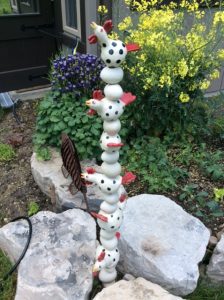 outdoor garden totem made in multiple pieces with black spotted chickens - Monika Schaefer