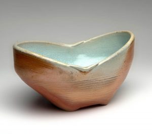 Manipulated form bowl with uneven rim, sky blue interior, copper exterior by Teresa Dunlop