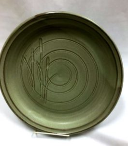 Green plate carved with concentric lines and bullrush plants - Liz Sine