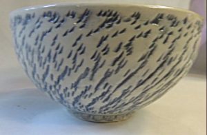Bowl exterior view with chattered surface inlaid with blue underglaze - June Goodwin