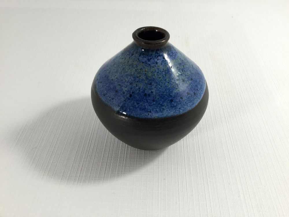 squat round vase with blue glaze from widest point to neck and black on the bottom - jane turner