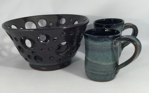 Pierced bowl in black and a pair of blue mugs with black interior - Maureen Reed