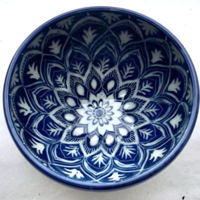 deep bowl in cobalt blue with carving in a mandala pattern through to the white clay below