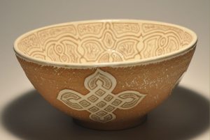 light red clay large bowl decorated with white slip and intricate sgraffito inside and medallions outside