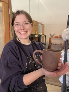 photo of Katie holding one of her mugs